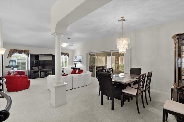 dining room featuring ornate columns, carpet flooring, and a chandelier