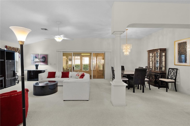 carpeted living area with decorative columns, a ceiling fan, a chandelier, and lofted ceiling