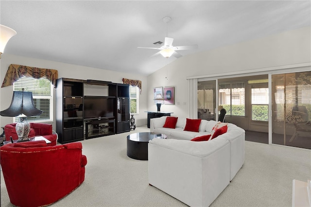 carpeted living room featuring lofted ceiling, a ceiling fan, and healthy amount of natural light