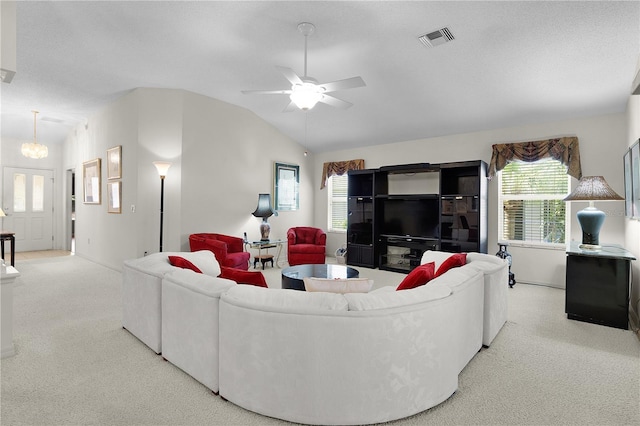 living area with carpet, lofted ceiling, plenty of natural light, and ceiling fan