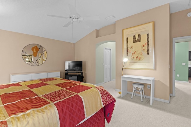 bedroom featuring carpet floors, vaulted ceiling, arched walkways, baseboards, and a ceiling fan