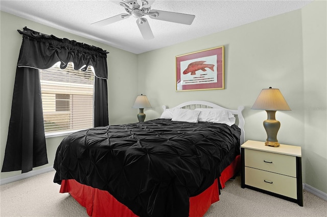 bedroom featuring light colored carpet, baseboards, a ceiling fan, and a textured ceiling