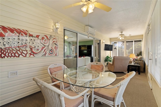 sunroom / solarium featuring a ceiling fan, outdoor dining space, and a wall mounted AC