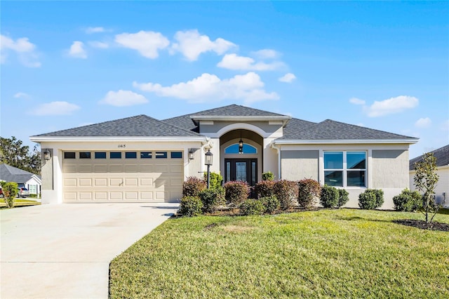 prairie-style house with a garage and a front lawn