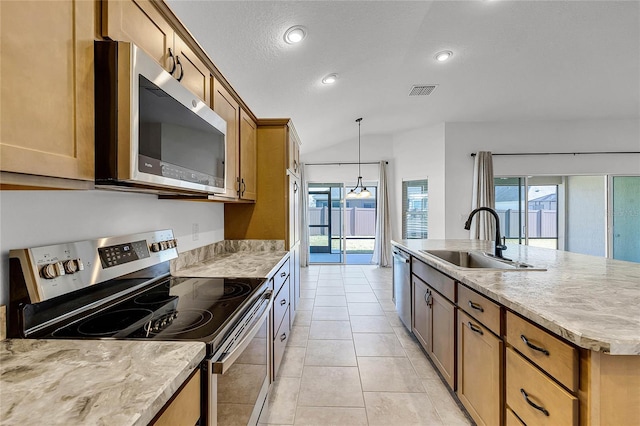 kitchen featuring appliances with stainless steel finishes, a wealth of natural light, sink, pendant lighting, and a center island with sink