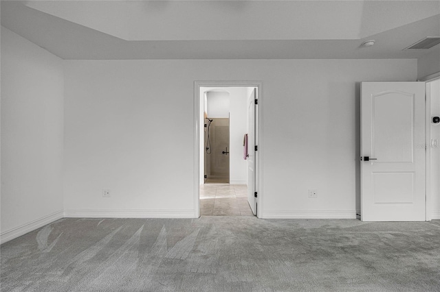 unfurnished room with light colored carpet