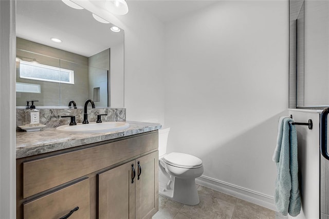 bathroom featuring vanity, toilet, and a shower with door