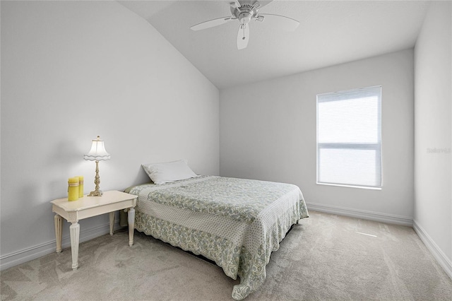 carpeted bedroom with vaulted ceiling and ceiling fan