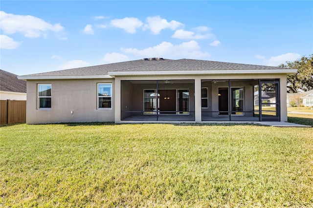 back of house with a sunroom and a yard