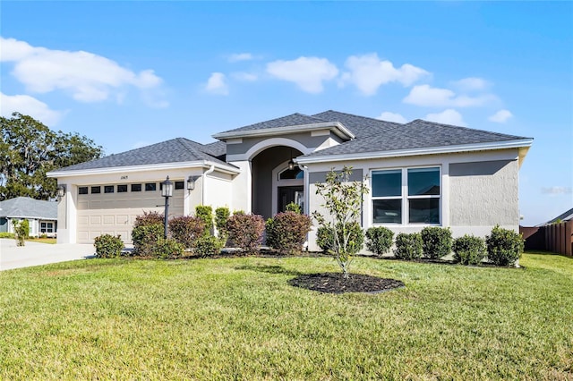 view of front of property with a garage and a front lawn