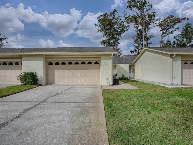 ranch-style home with a front yard and central AC