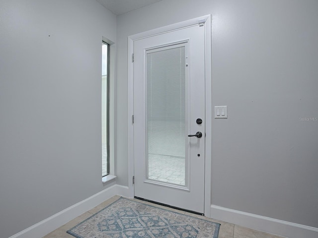 doorway to outside featuring light tile patterned floors