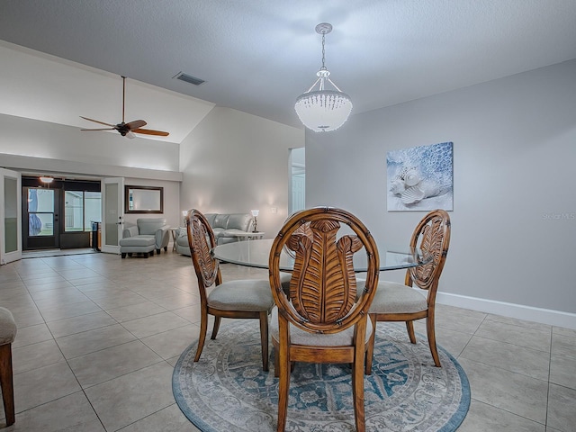 tiled dining area featuring ceiling fan, lofted ceiling, and french doors