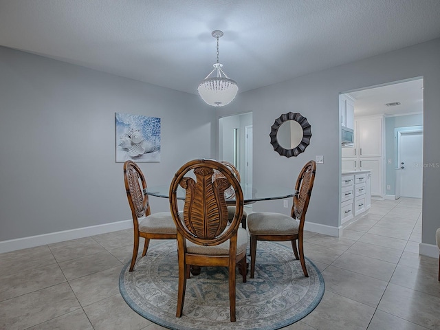 dining area with light tile patterned floors and a textured ceiling