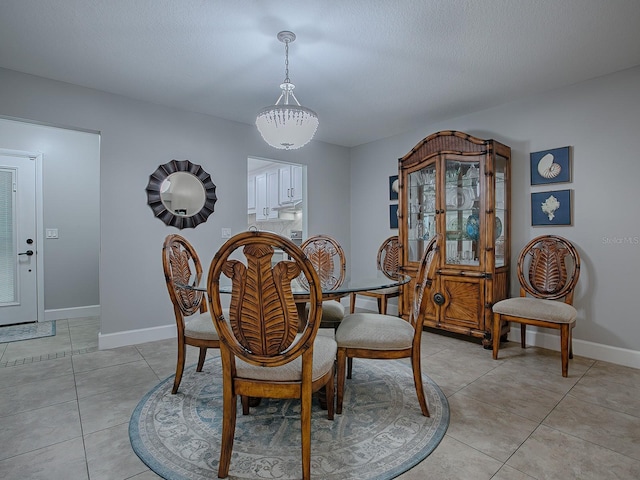 dining room with light tile patterned floors and a textured ceiling