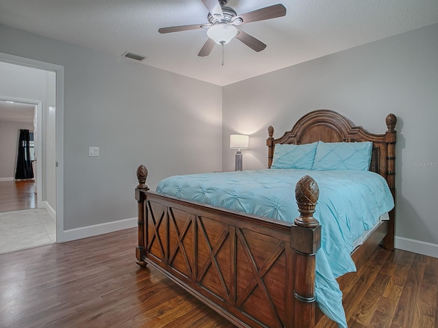 bedroom featuring ceiling fan and dark hardwood / wood-style floors