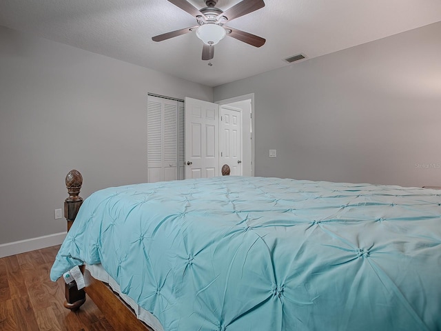 bedroom featuring ceiling fan, wood-type flooring, and a closet