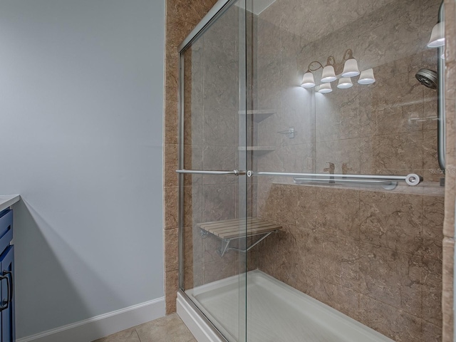 bathroom featuring tile patterned floors, vanity, and an enclosed shower