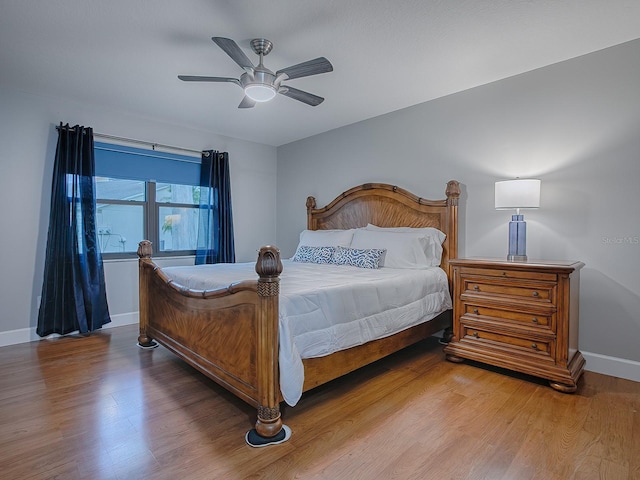 bedroom with ceiling fan and light hardwood / wood-style flooring