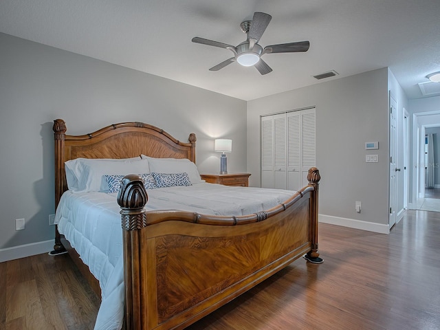 bedroom with dark hardwood / wood-style flooring, a closet, and ceiling fan