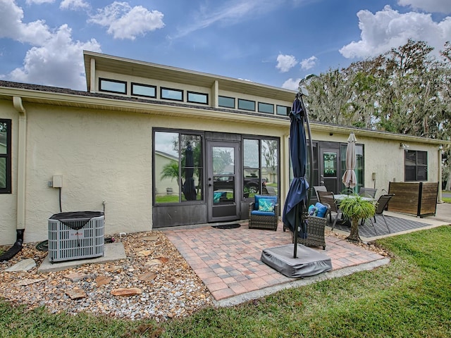 back of property featuring a patio area and central air condition unit