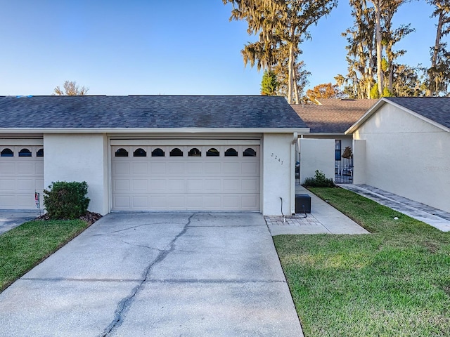 view of front of home with a front yard and a garage