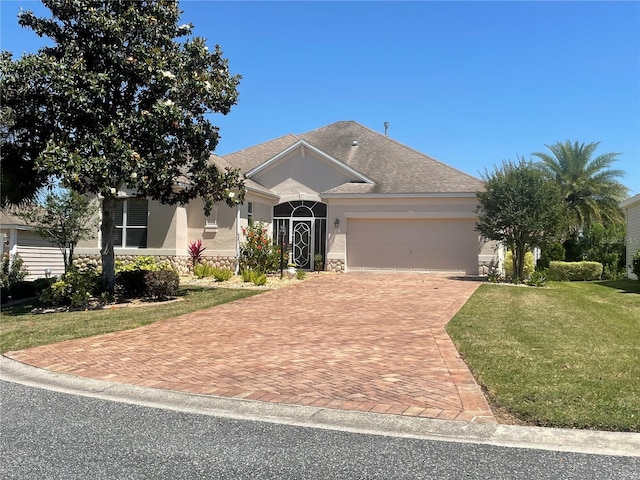 view of front of home with a garage and a front yard