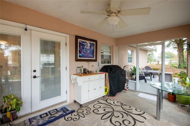 sunroom featuring french doors and ceiling fan