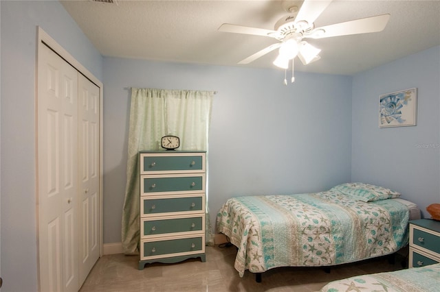 bedroom with ceiling fan and a closet