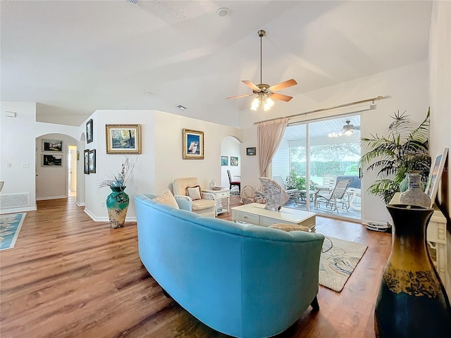 living room featuring ceiling fan, light wood-type flooring, and vaulted ceiling