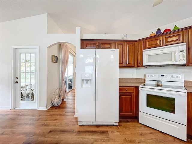 kitchen with light hardwood / wood-style flooring and white appliances