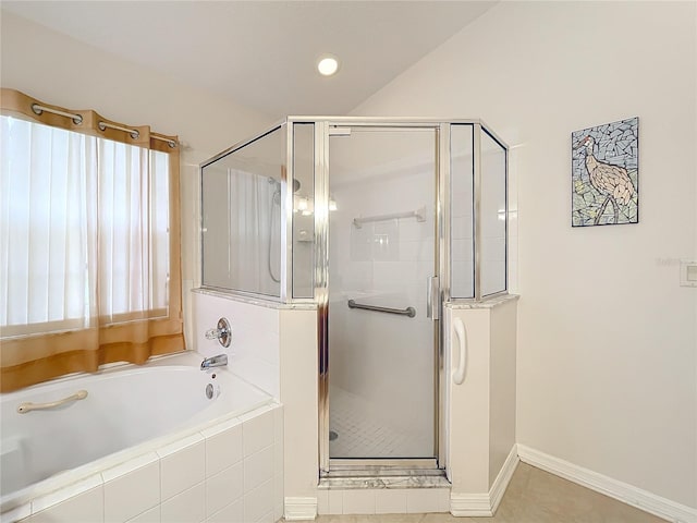 bathroom featuring tile patterned flooring and independent shower and bath