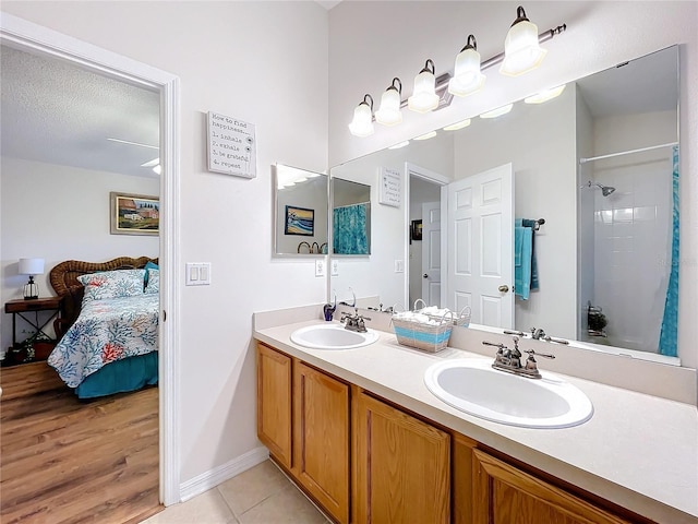 bathroom featuring tile patterned flooring, vanity, and a textured ceiling