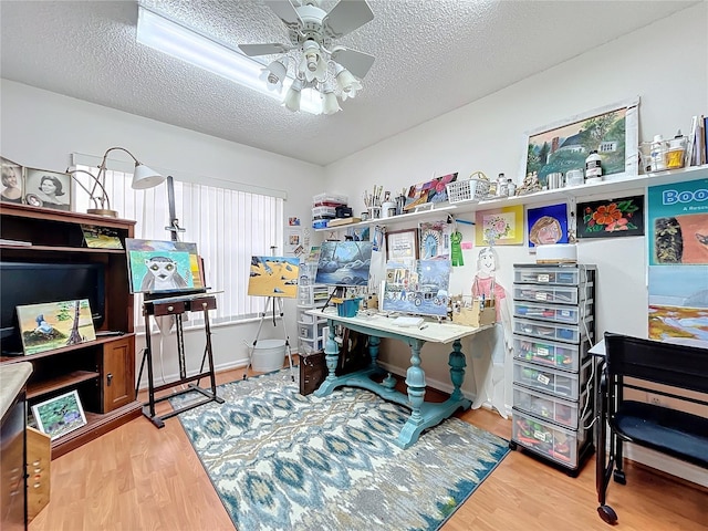 office area with hardwood / wood-style floors, a textured ceiling, and ceiling fan