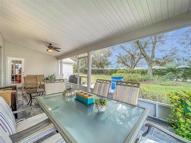 sunroom / solarium with ceiling fan and lofted ceiling