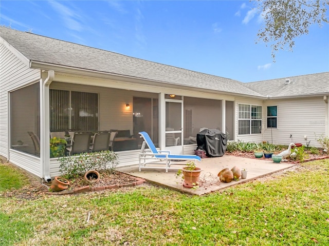 back of property featuring a sunroom, a yard, and a patio