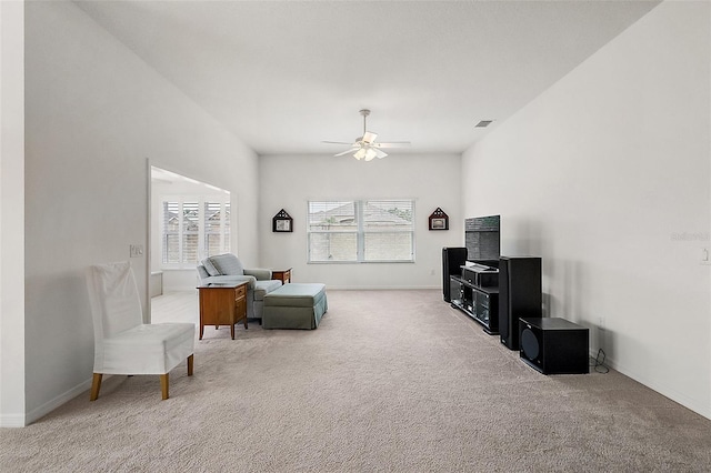 living room featuring ceiling fan, plenty of natural light, and carpet flooring