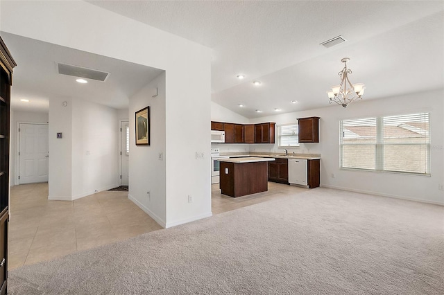 kitchen featuring white appliances, lofted ceiling, light colored carpet, pendant lighting, and a center island