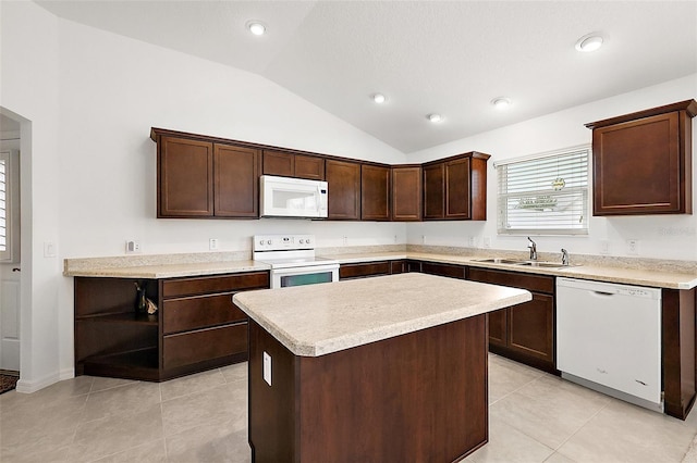 kitchen with white appliances, lofted ceiling, a kitchen island, sink, and light tile patterned flooring