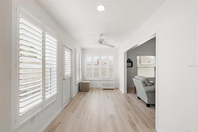 interior space featuring radiator and ceiling fan