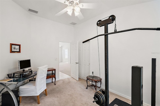 office area featuring ceiling fan, light colored carpet, and lofted ceiling