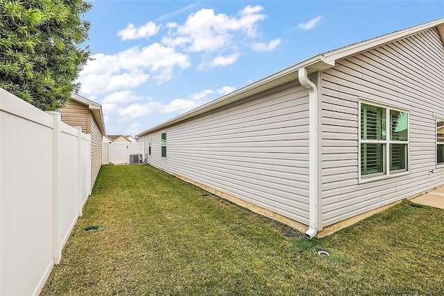 view of home's exterior featuring a lawn and central air condition unit