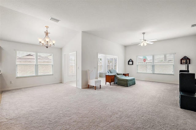 living room with ceiling fan with notable chandelier, plenty of natural light, and light carpet