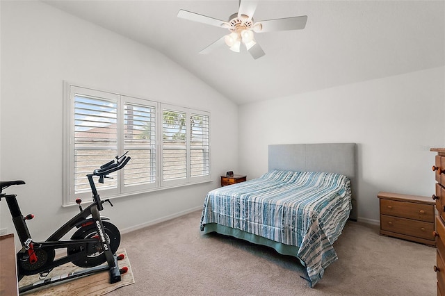 carpeted bedroom with ceiling fan and vaulted ceiling