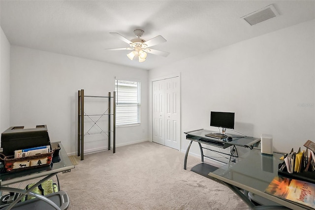 office space with light carpet and ceiling fan