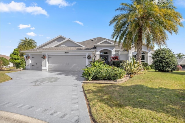 view of front of home featuring a garage and a front lawn