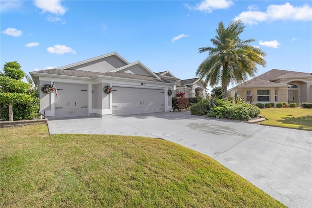 view of front facade with a front yard and a garage