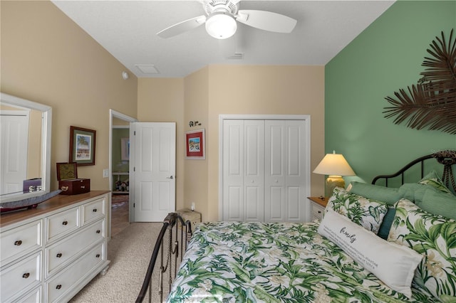 bedroom featuring ceiling fan, a closet, and light colored carpet