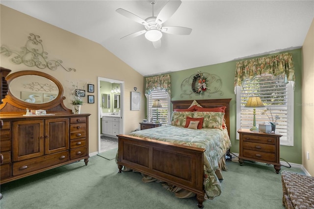 bedroom featuring ensuite bathroom, ceiling fan, light colored carpet, and vaulted ceiling