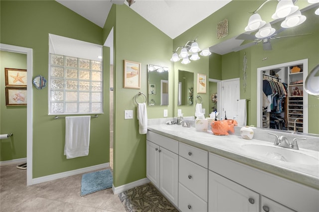 bathroom featuring ceiling fan, tile patterned flooring, vanity, and lofted ceiling